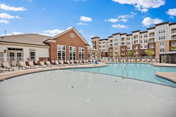 a pool with apartment buildings at Ellis Station, Durham, NC